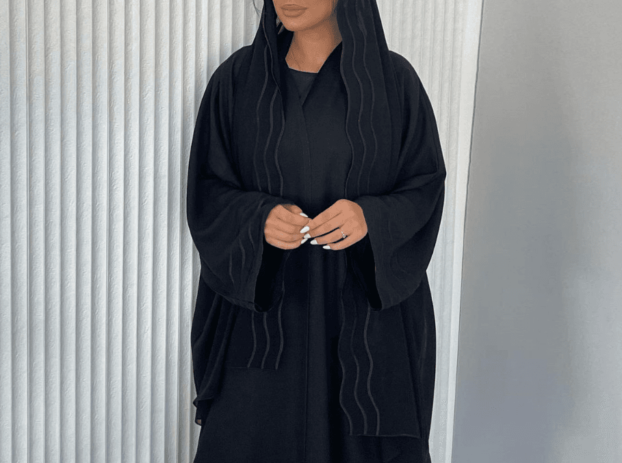 A Stylish, Loose-fitting Long Cardigan With Wavy Trim, Paired With Two Headscarves.