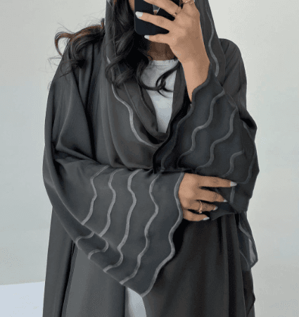 A Stylish, Loose-fitting Long Cardigan With Wavy Trim, Paired With Two Headscarves.
